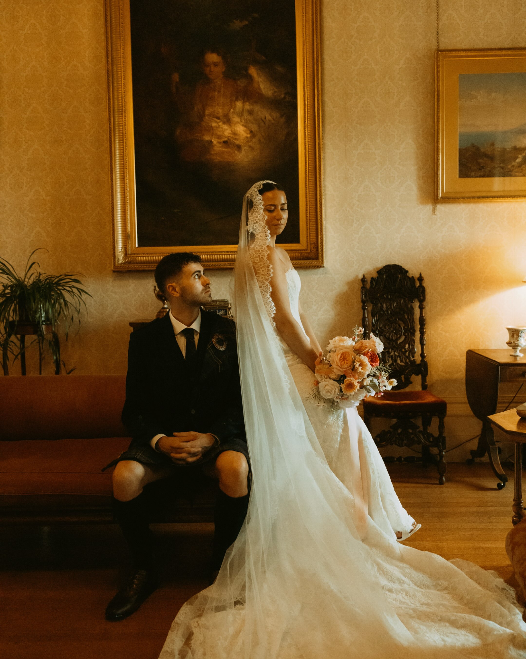 Bride and groom in a candlelit drawing room