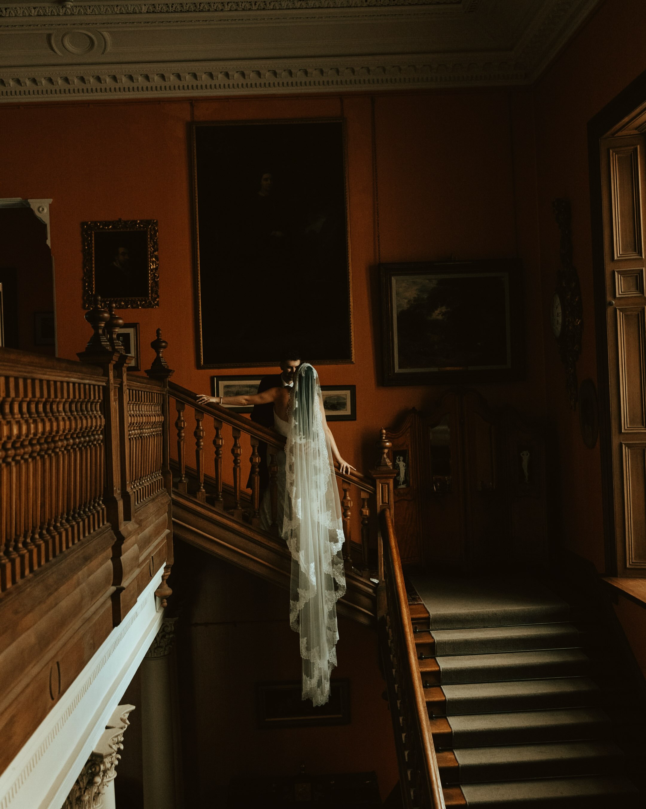 Bride on a grand staircase with a long lace veil
