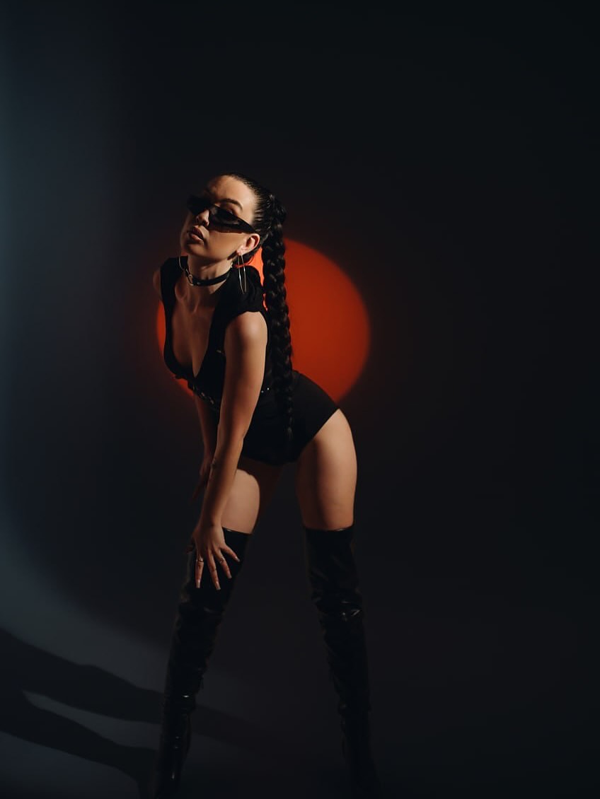 Studio portrait lit by a deep red glow