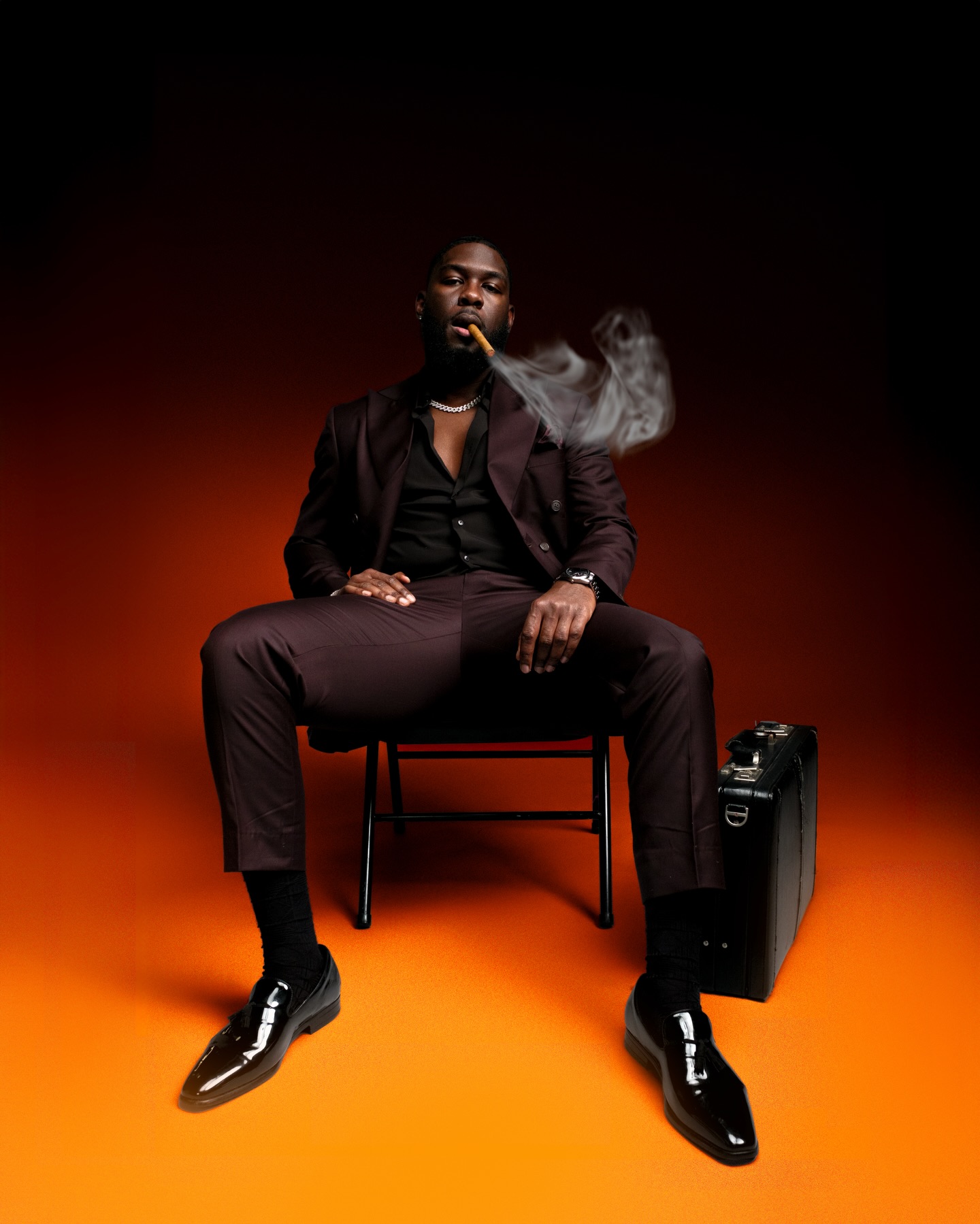 Studio portrait against a deep amber backdrop